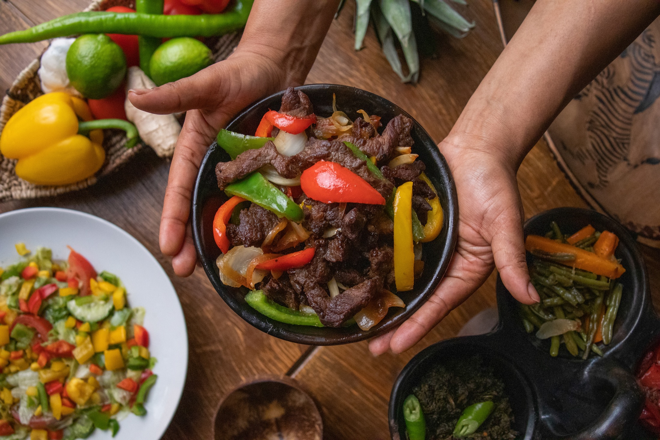 Signature Arada beef tibs bowl with peppers and fresh sides
